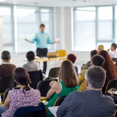 Business and entrepreneurship symposium. Speaker giving a talk at business meeting. Audience in...