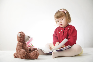 Story time. Little girl playing school with toys teddy bear and doll.  children education and development, happy childhood 