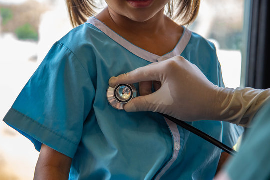 Pediatric Doctor or nurse use stethoscope examination cute girl  kid patient in clinic hospital healthy care concept