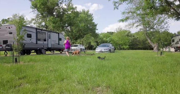 Woman Walks Towards RV with Dogs