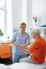 Pleasant nice nurse working with her patient