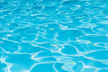 Fototapeta na wymiar Blue and bright water in swimming pool with sun reflection, Motion of ripple water and gentle wave in pool