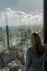 Fototapeta na wymiar Girl on Window with melbourne Skyline view city