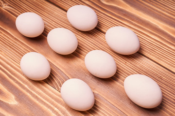 Chicken eggs laid on a wooden table