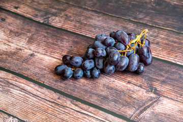 Seedless red grape on top of wooden table.