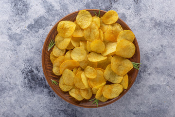 Crispy potato chips on the old kitchen table.View from above.