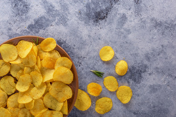 Crispy potato chips on the old kitchen table.View from above.
