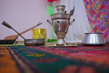 Crystal glass of tea on with metal samovar . cast iron old pot . Iron Wok very old . Azerbaijan tea samovar Concept traditional Azerbaijan culture object samovar .