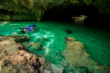 Some people is swimming and snorkeling on Gran Cenote Yucatan - obrazy, fototapety, plakaty