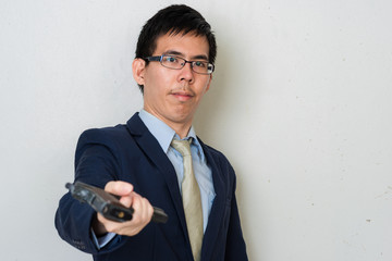 Business man in suit holding hand gun on white background