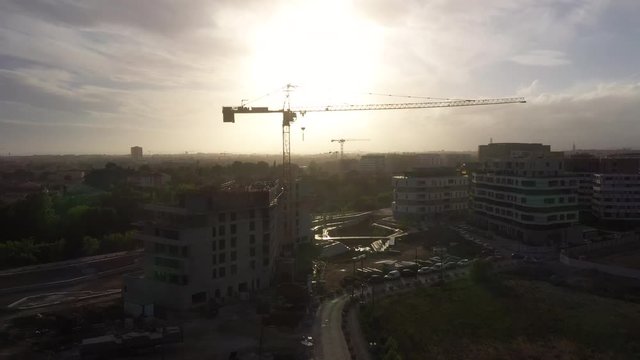 Construction crane silhouette during sunset aerial Montpellier rive du lez Port Marianne