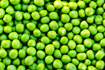 Green peas on wooden background. Healthy food. Dark rustic style.