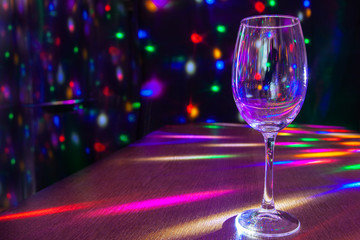 glass on the table with bright festive lighting