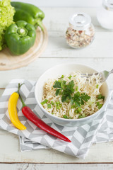 Cooked instant noodles served on a wooden table with chili pepper, parsley and green onion. Fast and easy recipe. Quick noodles