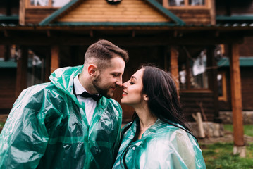 couple in love kissing in the rain on their doorstep