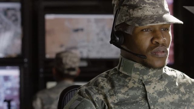 Military drone operator operator reading his computer, close up