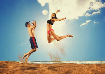 Beach volleyball player in action at sunny day under blue sky
