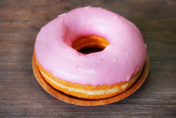 Donut with strawberry cream on the table