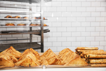Fresh pastries on counter in bakery store. Space for text