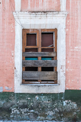 Old Windows with broken glass and broken frames in the old house.