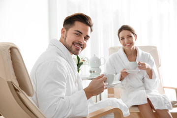 Fototapeta premium Romantic young couple with tea in spa salon
