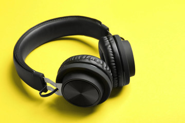 Fototapeta na wymiar Stylish headphones with pads on color background