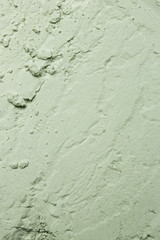 Green powder textured background, close up