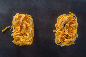 Yellow Egg noodles rectangles on stylish black background