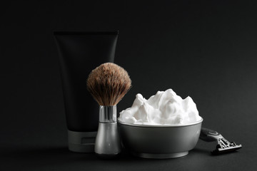 Set of shaving equipment and men's cosmetic products on black background