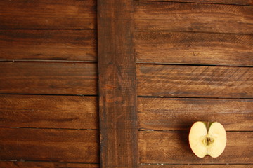 red apple cut in half on wooden background