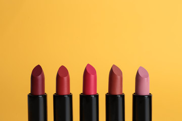 Obraz premium Different lipsticks on color background. Makeup cosmetic product