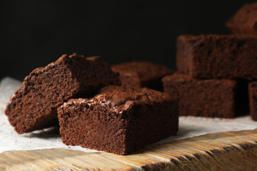 Fresh brownies on wooden board. Delicious chocolate pie