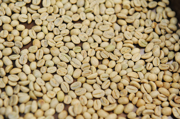 Raw unroasted green coffee beans. Top view texture