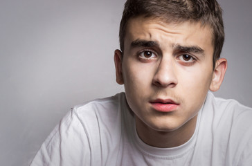 Obraz premium Closeup portrait confused young man. Human facial expression, body language