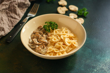 pasta farfalle with julienne mushrooms (fresh dish). food background. top