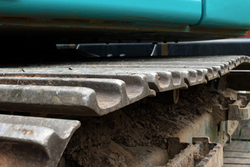 Close up of excavator track. Copy space for text. Conceptual image of construction site.