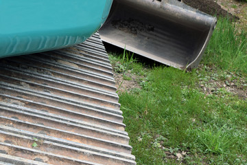 Excavator track close up. Shovel on background. Space for text.