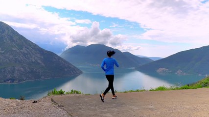 Thee Mountains And Sea View. Montenegro. Landscape.The Woman Is Running And Doing Exercises On The Cliff.