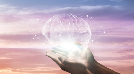 Male hands holding hologram of human brain with network connections