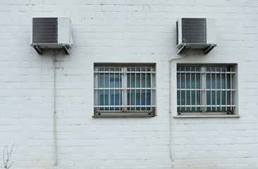 Fototapeta na wymiar Air conditioner installed outside the building on white wall.