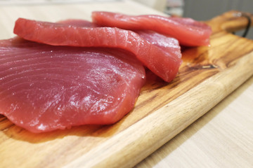 Tuna steak on a wooden board, tasty fish dinner