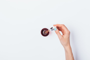 Woman's hand holding pipette