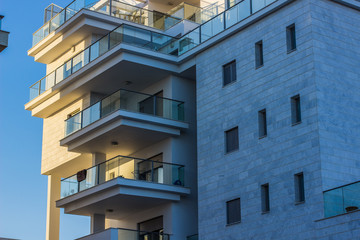 outside wall of city building apartments windows and balcony 