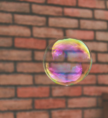 Soap bubble on brick background 