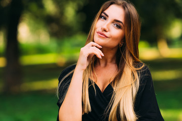 beautiful young woman looking into the camera. hand around the f