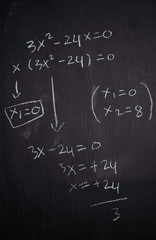 Close up math formulas written on a blackboard. Education concept