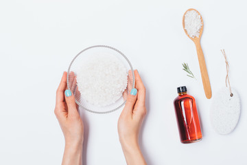 Top view female's hands holding bowl of sea salt