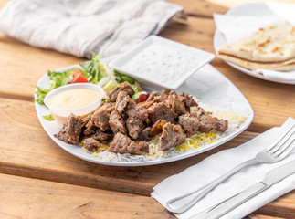 Lamb gyro platter served at a Greek Mediterranean restaurant. 