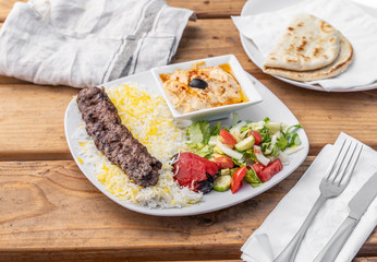 Delicious beef kafta served with rice and hummus in a Greek Mediterranean restaurant.