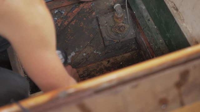 Drying bilge of old wooden boat checking for water leaks